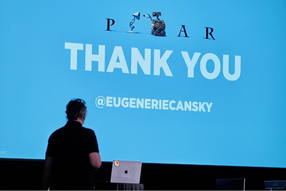A speaker closing their talk in front of a thank-you slide